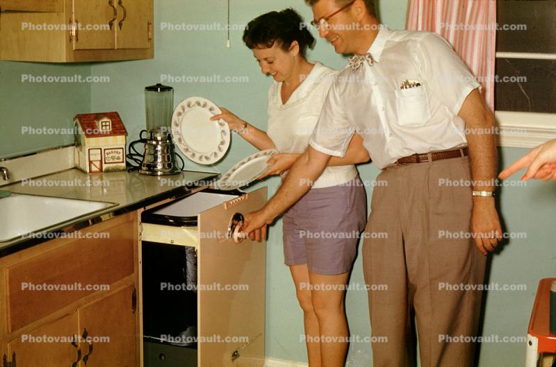 Woman and Man doing the dishes, automatic dishwasher, July 1959, 1950s