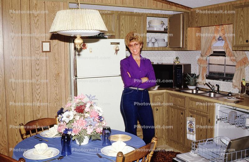 Smiling Lady in Kitchen, Jeans, Lamp, Sink, Table Setting, Flowers, Microwave Oven, 1986, 1980s