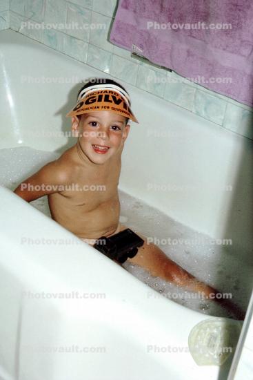Boy in tub, washing, cleaning, smiles, hat, bathwater, water, bathtub