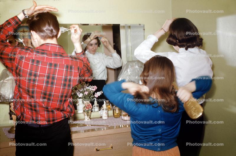 Brothers and Sisters grooming in front of the Mirror, 1950s