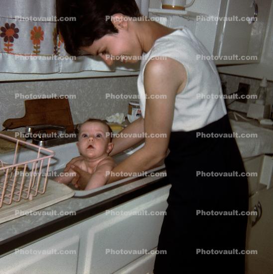 Mother Washes Baby in Sink, 1950s
