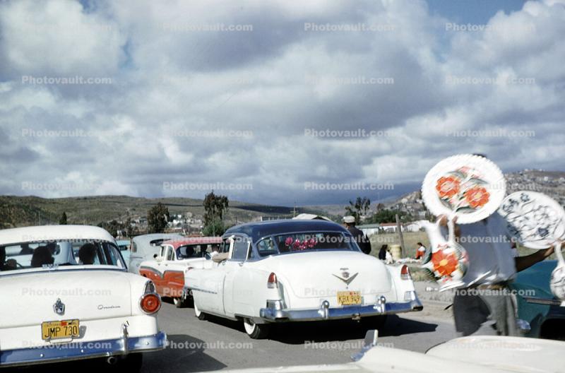 Mexican Side of The Border crossing, Vendors Selling their Wares, Cadillac Car, Ford Custom, 1950s