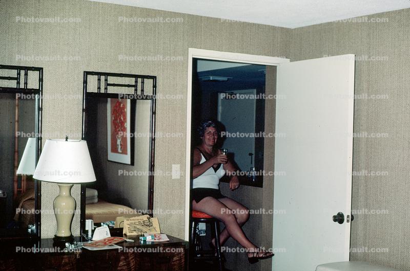 Woman in a hotel room, longline bra