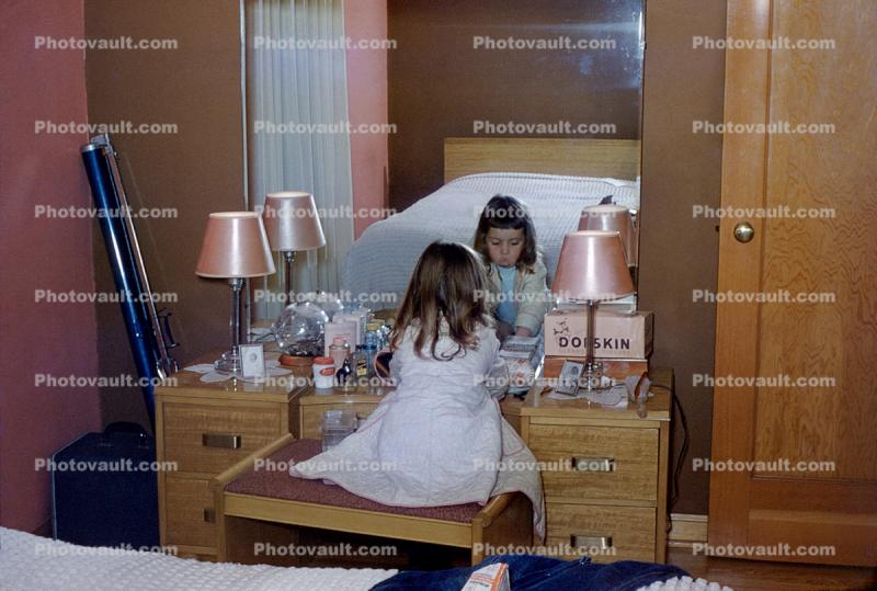 Little girl at moms vanity, mirror, playing with make-up, Pink Lampshades, 1950s