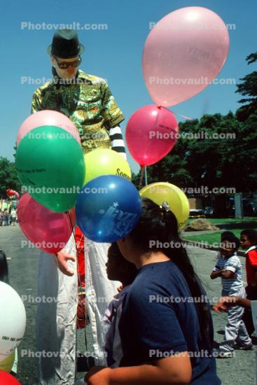 Helium Balloons and Man on Stilts