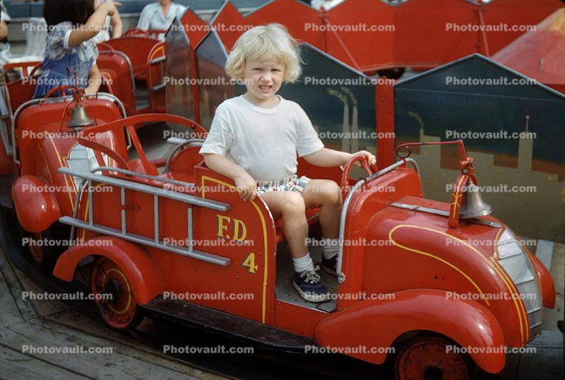 Unhappy Little Girl in a Fair Firetruck Ride, 1950s
