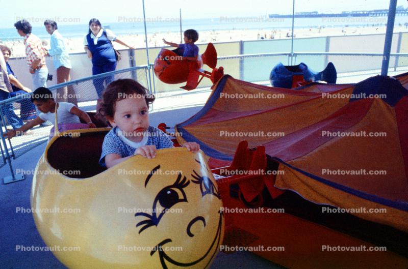 toddler on a ride, kiddie ride, funny face, 1950s