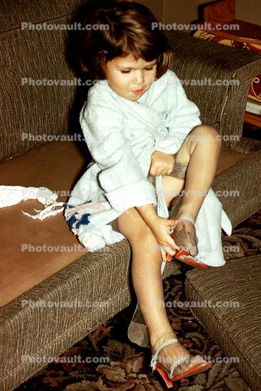 Little girl trying on Stockings and new Shoes, High Heels, 1950s