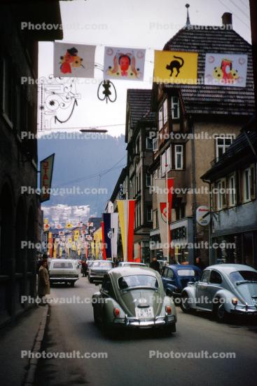 Volkswagen, cars, street, buildings, Parade, Fasnet, Carnival, flags, banners, Schramberg, Baden-Wurttemberg, Black Forest, Germany, spectators