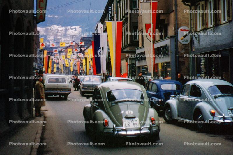 Volkswagen, cars, automobile, vehicle, street, Parade, Fasnet, Carnival, flags, banners, Schramberg, Baden-Wurttemberg, Black Forest, Germany, 1950s