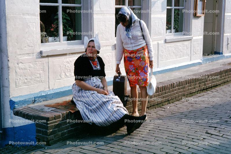 Women, native dress, hats, brick road, building, Holland