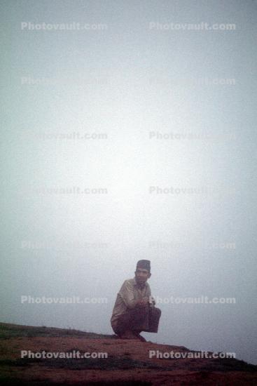 Man Croutching in the Fog, Nepal