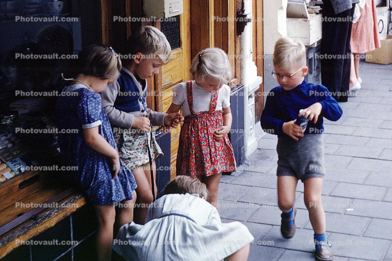 Boys, Girls, playing a game on the sidewalk, Groninger, Netherlands, September 1959, 1950s