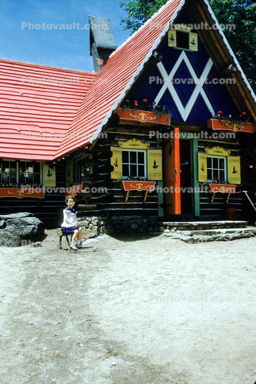 Building, Windows, door, red roof, girl, sitting, log cabin, Santa's Workshop, Elaine, North Pole, Adirondack Mountains, 1953, 1950s