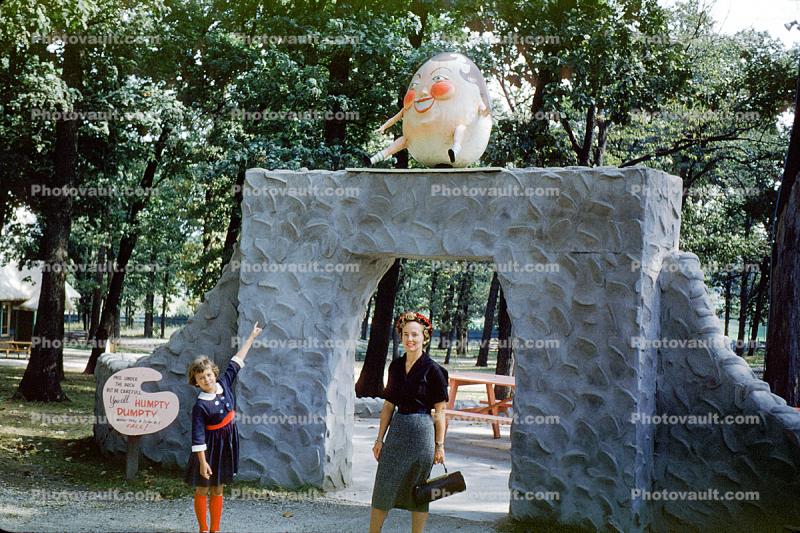 Humpty Dumpty, girl, woman, dress, purse, gate, wall, storybook, September 1959, 1950s