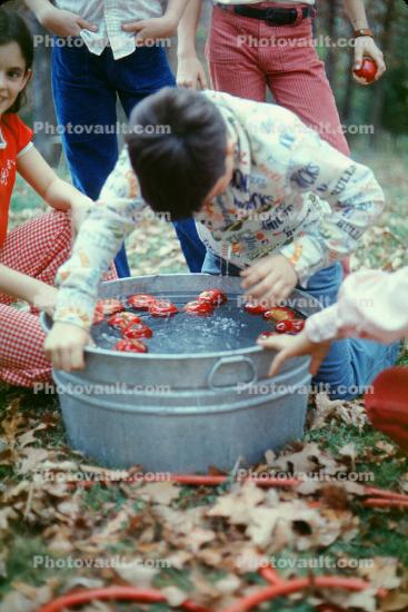 Bobbing for Apples, Boy, bucket, water, March 1975, 1970s