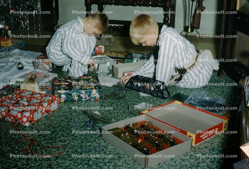Boys playing with their new Christmas toys, army, presents, pajamas, 1950s