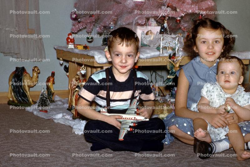 Brother, Sister, siblings, baby, toddler, Boy with Airplane Model, 1950s
