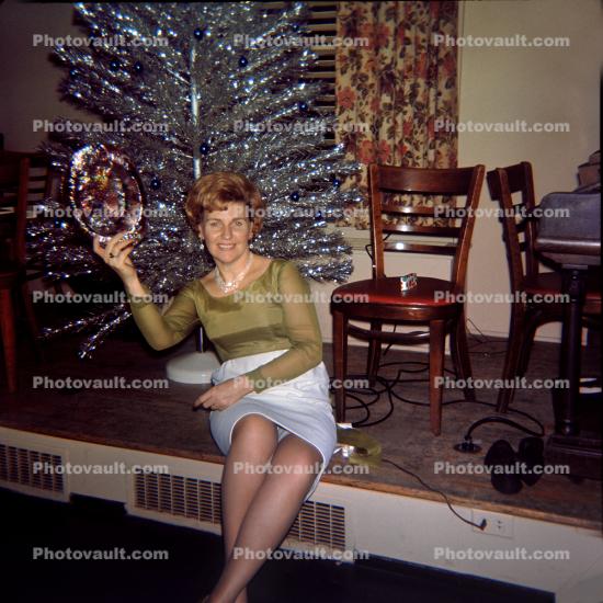 Women hold up present, Aluminum Tree, December 1967, 1960s