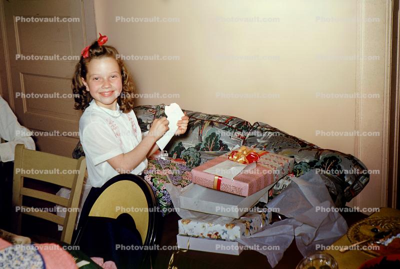 Smiling girl and her Christmas Presents, 1950s