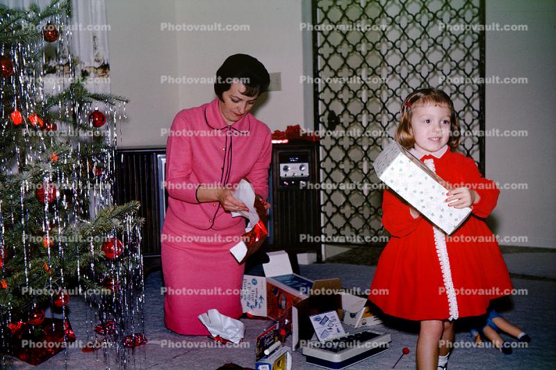 Mother and Daughter unwrapping presents, 1950s