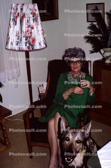 Woman sitting with drink, lamp shade