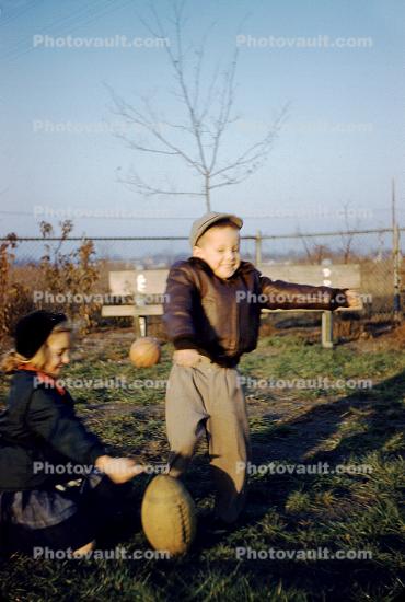 Lucy and Peanuts kicking a football, 1940s