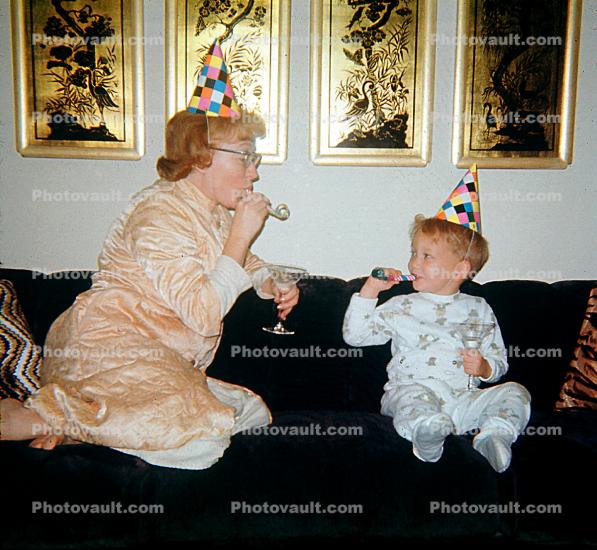 Mom and Son partying, noisemaker, Robe, Pajama, party hat, cap, nightwear, Mother, Son, Sofa, Couch, jammies, pajamas, birthday hats, 1950s