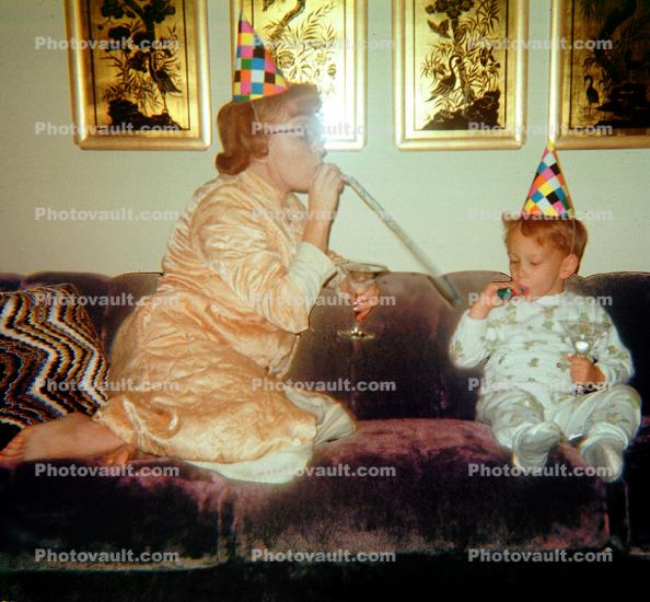 Mother, Son, Sofa, Couch, jammies, birthday hats, 1950s, Mom and Son partying, noisemaker, Robe, Pajama, party hat, cap, nightwear