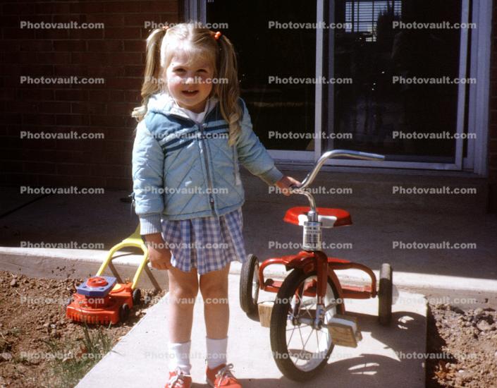 Girl, Smiles, Tricycle, Jacket, Skirt, backyard, 1960s