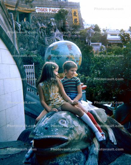 sitting on a fish sculpture, globe, 1960s