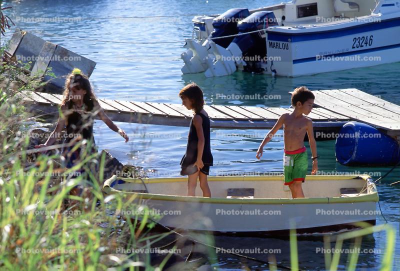 small rowboat, docks, water, boy, girls, Noumea, New Caledonia