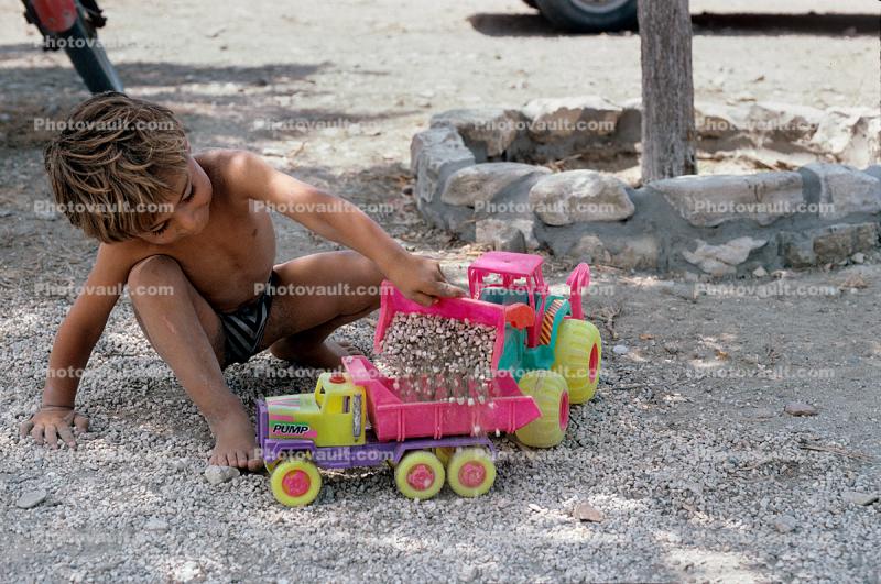 dump truck toy, Boy, pebbles, rocks, tractor