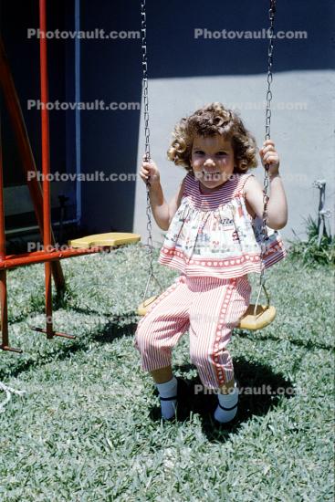 girl on a swing, backyard, 1950s