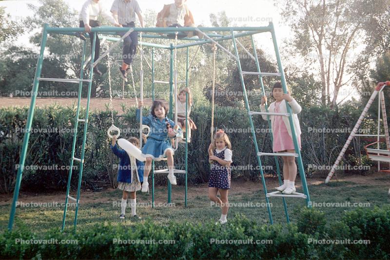 swing set, girls, backyard, Riverside California, April 1970, 1970s