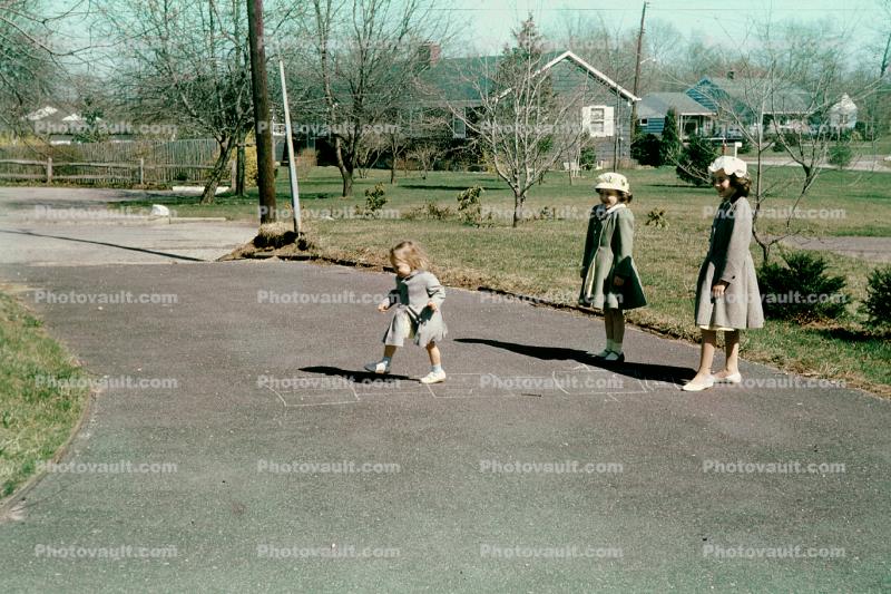 Hopscotch, driveway, girls, hats, coats, Backyard, May 1965, 1960s