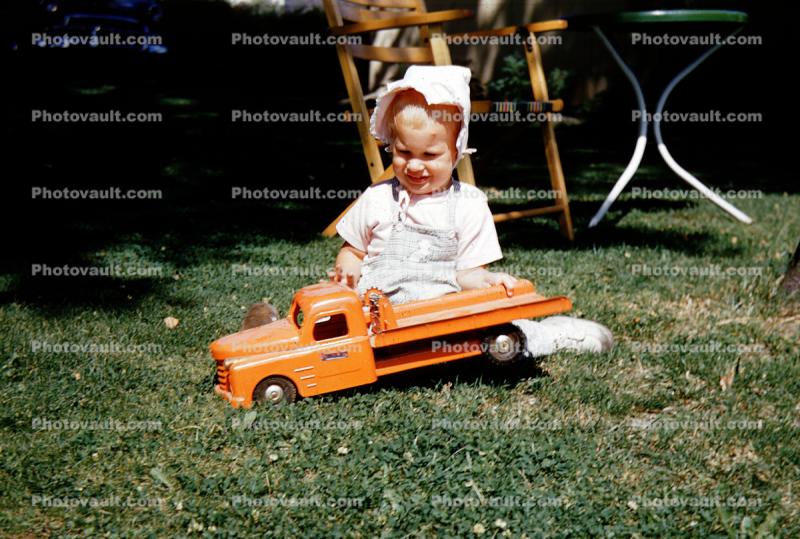Girl Playing with Toy Truck, bonnet, 1954, 1950s