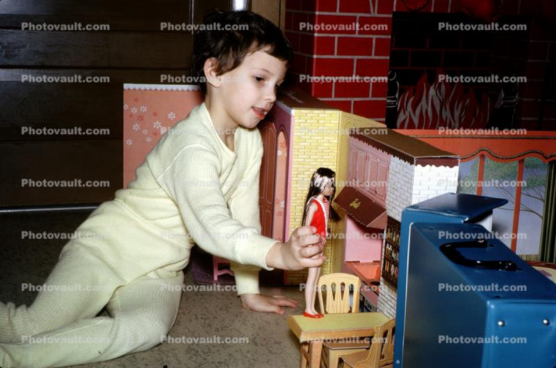 Girl Playing House with her Barbie Doll, pajama, December 25 1964