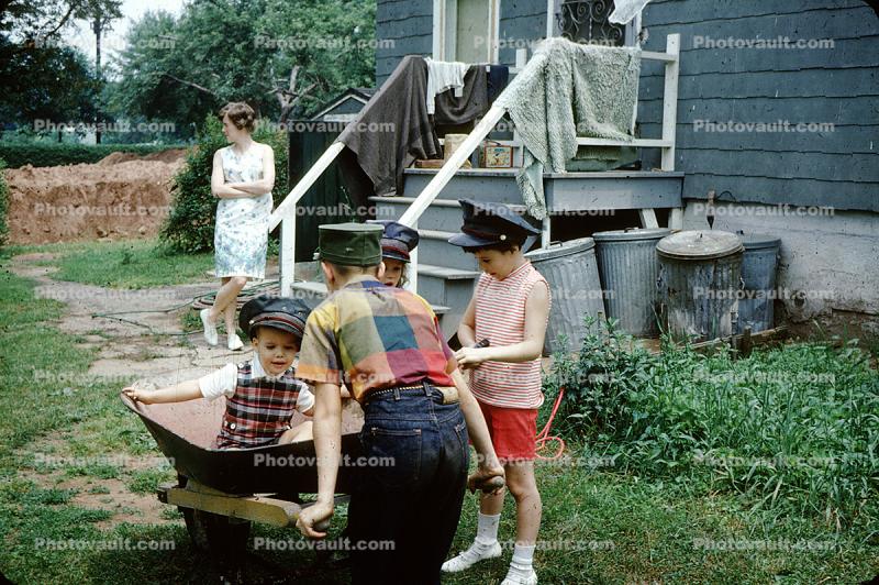 Wheelbarrow, backyard, hats, trash cans, June 1966