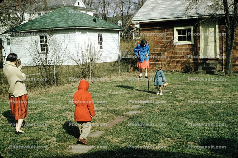 Girl on Stilts, backyard, coats, cold winter, Mother with Movie camera, 1950s