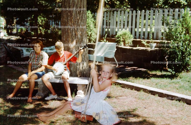 Back Yard, Girl on Swing, boy playing banjo, June 1965, 1960s