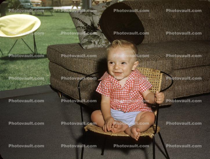 Toddler Boy Sitting on a chair, Smiles