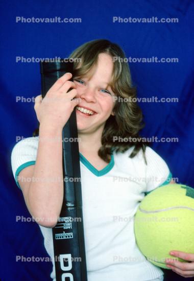 Smiling Girl with Oversize Tennis Racquet and Tennis Ball, 1970s Hairdo