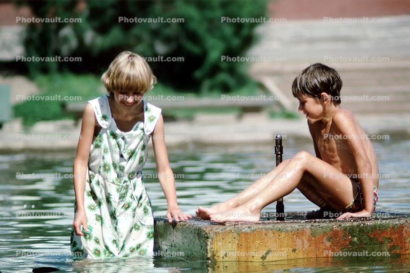 Girl and Boy playing in the town Pond, Fountain, Bratsk, Siberia