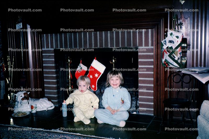 Girls, fireplace, santa stockings, 1960s
