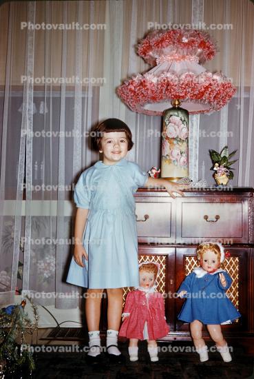 Little Girl with her Dolls and a Pink Lampshade
