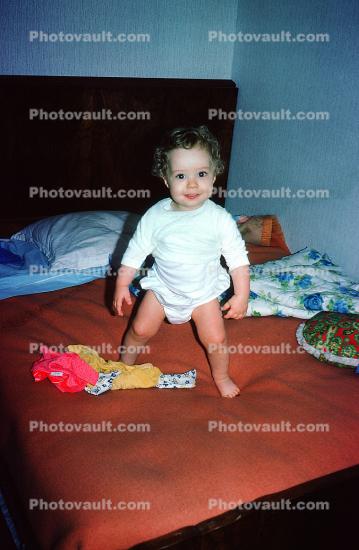 Girl Standing on a Bed, Diapers, Blankets