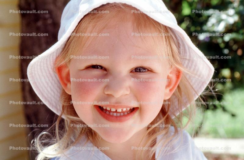 Smiling Girl wearing a hat, happy face, joy