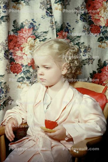 Girl Sitting, Pink Robe, Flowery Cutrains, Holding teacup, 1940s