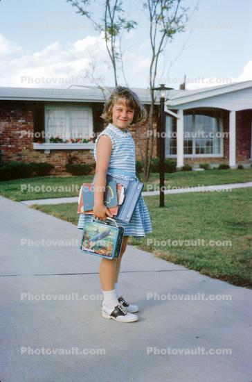 Schoolgirl ready for the day, saddle shoes, lunchpail, books, dress, smiles, home, house, Chicago, October 1962, 1960s